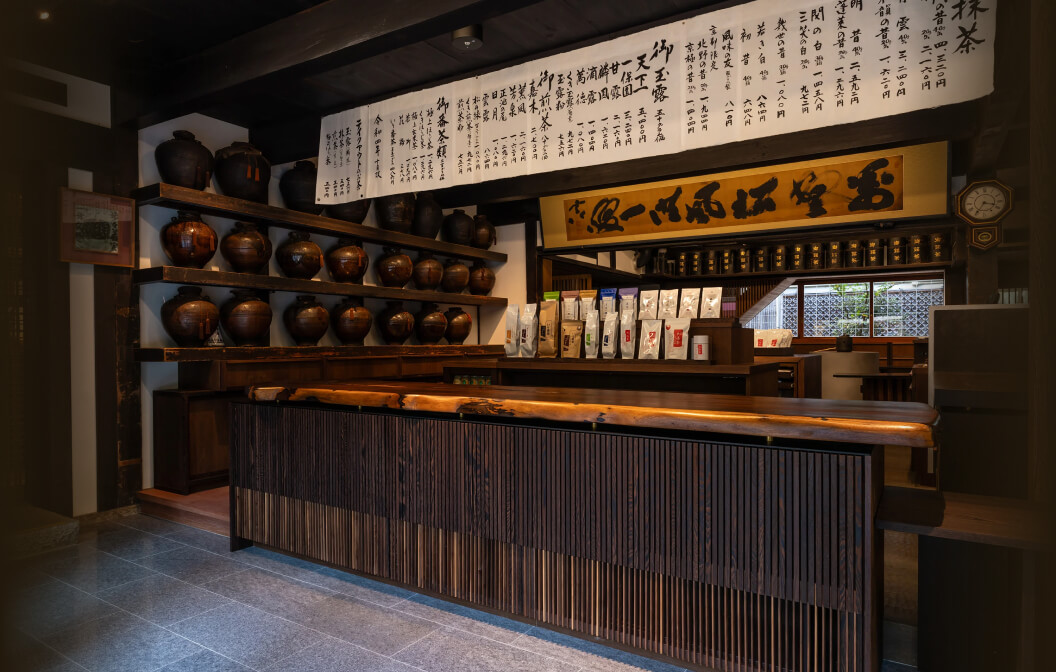 Front of Ippodo Tea flagship store, tearoom and headquarters black storefront in Kyoto, Japan with outdoor lit neon sign