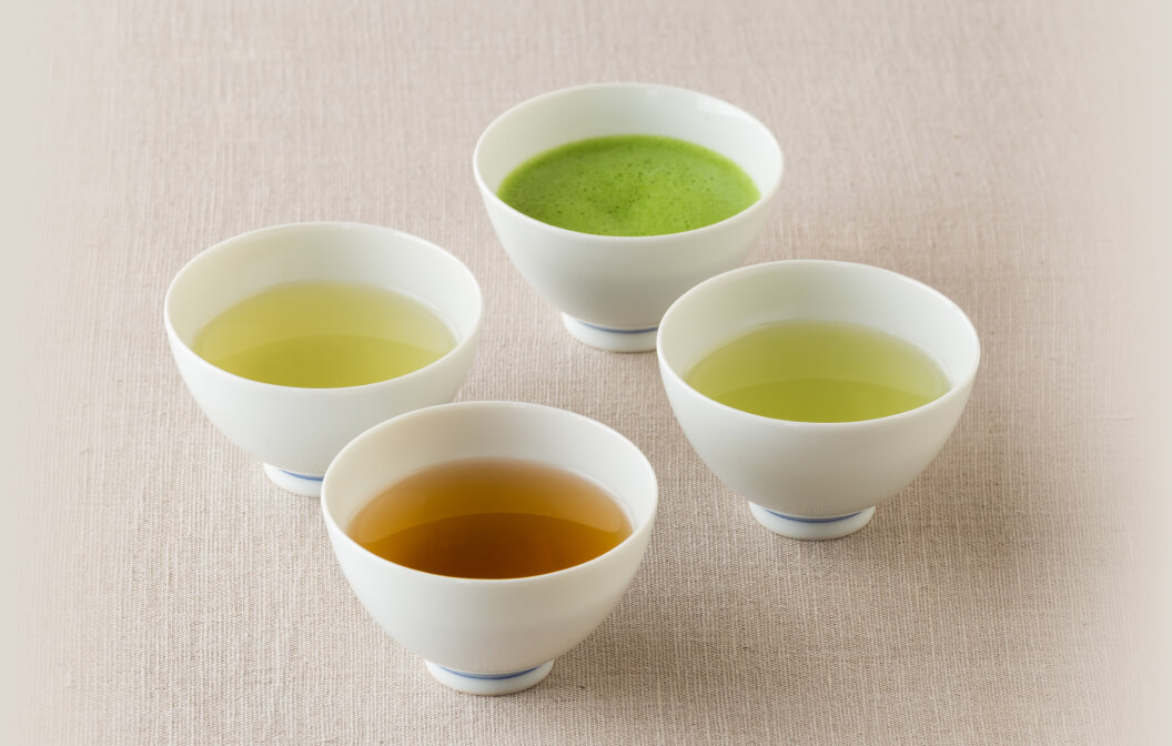 Four white teacups from Ippodo Tea containing different types of tea